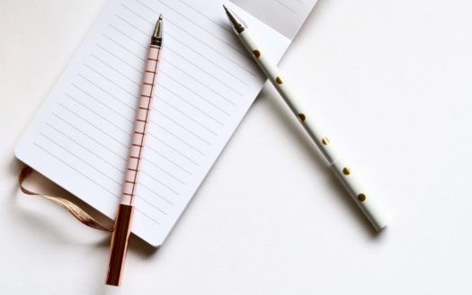 Pen and opened lined notepad.